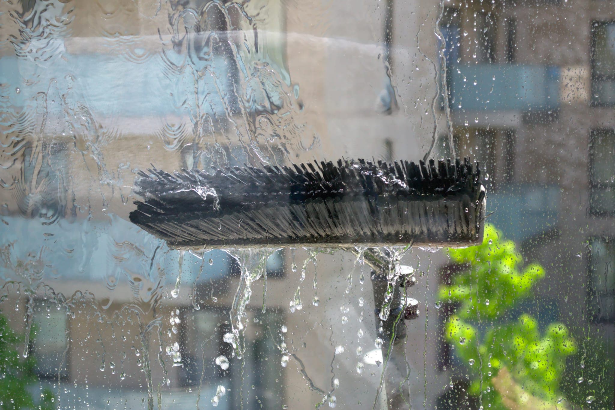 Pure water window cleaning in Barnsley - water-fed brush washing a pane of glass